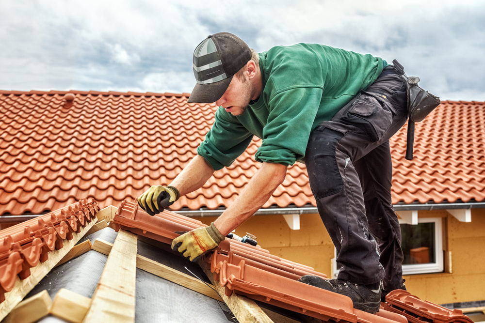 Roofer,At,Work,,Installing,Clay,Roof,Tiles,,Germany